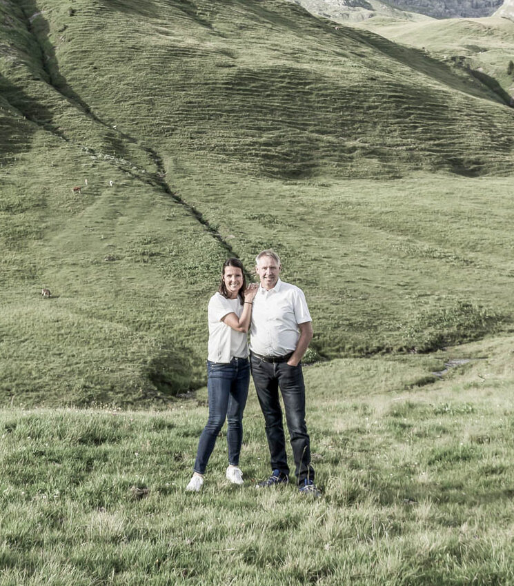 Vermieterpaar Michaela und Elmar auf grüner Wiese | Aadla Chalets